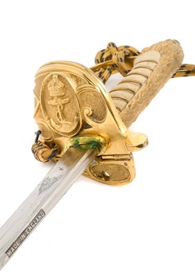 Lot 67 - Good George VI Naval Officer's dress sword with gilt lion's head pommel, wire bound shagreen grips, Gothic guard with crowned fouled anchor and original bullion dress knot, etched fullered blade...