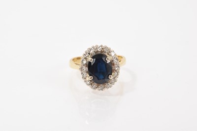 Lot 613 - Sapphire and diamond cluster ring
