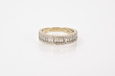 Lot 614 - Diamond half eternity style ring with a band of baguette cut diamonds flanked by a border of brilliant cut diamonds in 14ct white gold setting