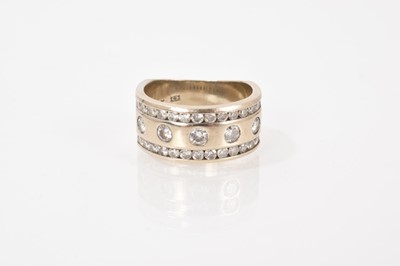 Lot 615 - Diamond wide band ring with five brilliant cut...