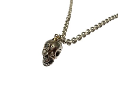Lot 108 - White metal skull pendant with diamond set eyes and a hinged compartment containing a moonstone cabochon