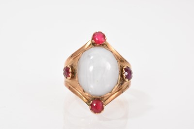 Lot 658 - Gold and gem-set 'bishop' ring with a cabochon star sapphire and red stones in gold setting with engraved bishop's mitre, ring size P.
