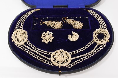 Lot 662 - 19th century seed pearl parure comprising a necklace, earrings and brooch, each with seed pearls stitched to finely pierced mother of pearl panels, in fitted leather box
