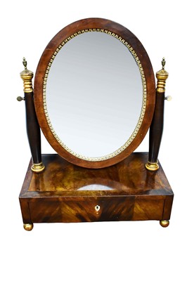 Lot 1513 - 19th century Biedermeier mahogany and gilt metal mounted toilet mirror, with oval swing plate and single drawer to the pedestal base on ball feet, 56cm wide