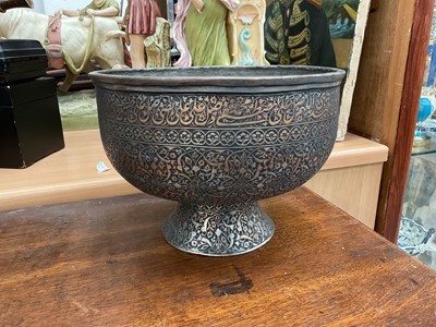 Lot 110 - Persian footed metal bowl decorated with Arabic script and foliate patterns, 24.5cm diameter