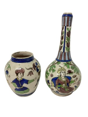 Lot 202 - Two Persian tin glazed vases, decorated with figures and foliage, 30.5cm and 16.5cm high