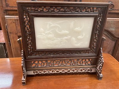 Lot 211 - Chinese jade and pierced wood table screen decorated with fish and calligraphy