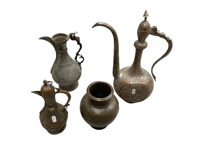 Lot 105 - Three Persian metal ewers and a vase, with engraved and relief decoration