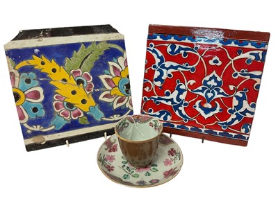 Lot 204 - 18th century Chinese Batavian ware famille rose high-sided porcelain tea bowl and saucer, together with two Persian tiles