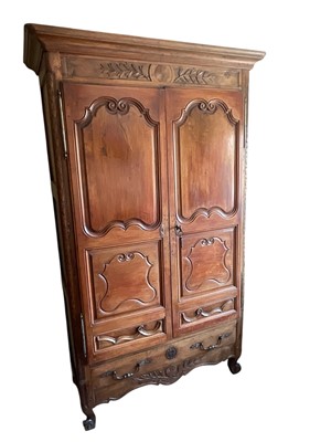 Lot 1553 - 18th century French fruitwood armoire, enclosed by two carved and fielded panelled doors with drawer below on carved scroll feet