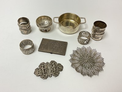 Lot 6 - Group of silver and white metal, mostly Indian and Middle Eastern, including napkin rings, cigarette case, buckle, filigree dish, and a small bowl, together with a continental 800 silver twin-ha...