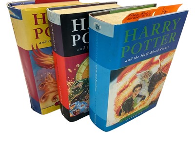 Lot 1416 - Three First Edition Harry Potter books to include the Half-Blood Prince with rare page 99 printing error with the misprint 'eleven owls'. Order of The Phoenix and Deathly Hallows. (3)