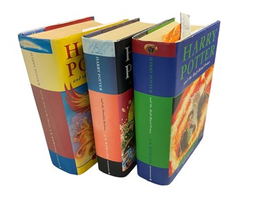 Lot 1418 - Three First Edition Harry Potter books to include the Half-Blood Prince with rare page 99 printing error with the misprint 'eleven owls'. Order of The Phoenix and Deathly Hallows. (3)