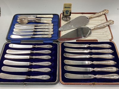 Lot 1134 - Two cased sets of six silver handled butter knives, two silver handled cake slices, plated cutlery and a silver calendar holder