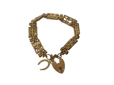 Lot 213 - 9ct gold gate bracelet with padlock clasp, with an 18ct gold horseshoe charm