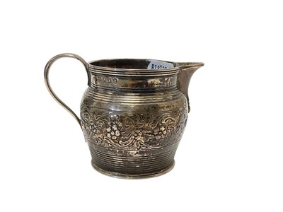 Lot 92 - George III silver cream jug with reeded decoration and central band of chased decoration, (London 1801), makers mark rubbed, 7cm in overall height,...