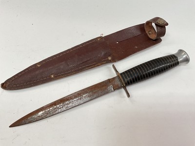 Lot 363 - Second World War era fighting knife in leather sheath.