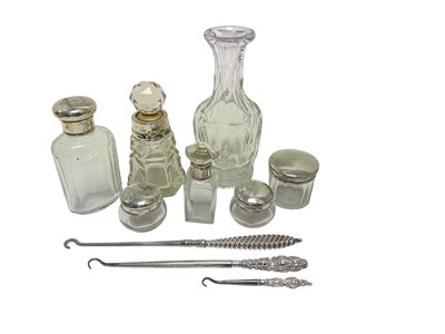Lot 176 - Six silver topped and silver collar glass toiletry bottles and three silver handled button hooks
