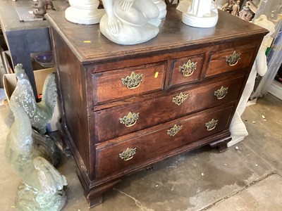 Lot 1340 - A George II elm chest of drawers, the moulded rectangular top above three short and three long drawers on ogee feet, 98cm wide, 52cm deep, 86cm high.
