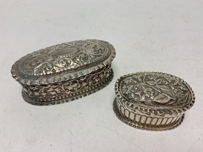 Lot 1046 - Two Victorian silver oval trinket boxes with embossed floral scroll decoration