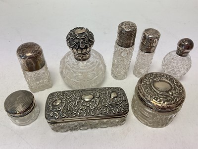 Lot 1054 - Group of silver topped glass scent bottles and vanity jars (8)