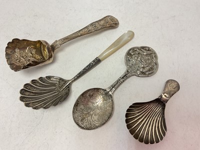 Lot 1064 - Three silver caddy spoons and one white metal (4)