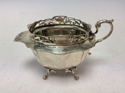 Lot 246 - Unusual silver jug with pierced border and four feet (Sheffield 1911)