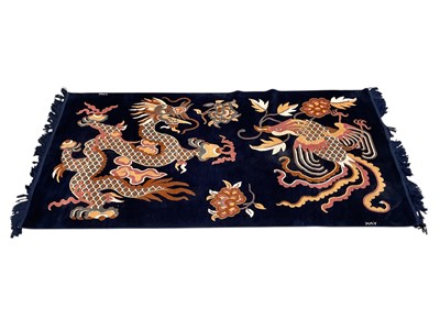 Lot 1434 - Chinese dragon and phoenix rug signed 'YAK'