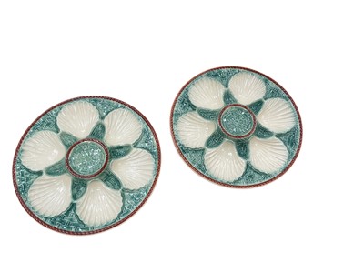 Lot 405 - Pair of French majolica oyster plates with basket weave moulding, painted green and cream, 24cm diameter