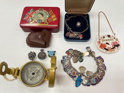 Lot 1154 - Two silver and enamel souvenir charm bracelets, brass compass and sundry items