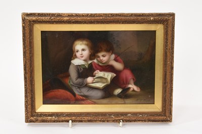 Lot 224 - A 19th century continental porcelain plaque depicting two children reading a book, signed C.L. Vogel, in glazed gilt frame