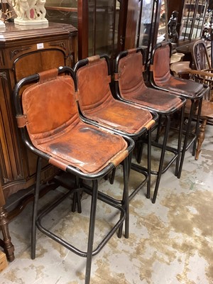 Lot 1310 - A set of four brown leather and painted tubular metal bar stools in the style of Charlotte Perriand