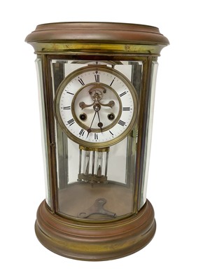 Lot 669 - French oval brass cased four glass mantel clock