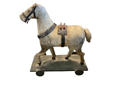 Lot 162 - Folk art child's model of a horse, on wheel base, 20cm high