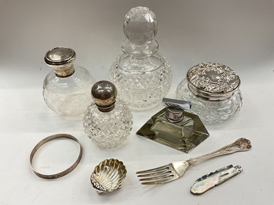 Lot 1093 - Two silver mounted glass scent bottles, silver mounted glass powder pot, other bottles, silver shell salt, silver bangle, Victorian silver and other of pearl fruit knife and a plated fork