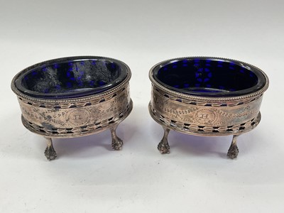 Lot 1023 - Pair of Georgian silver salts with blue glass liners on claw and ball feet (London 1794), maker James Waters.