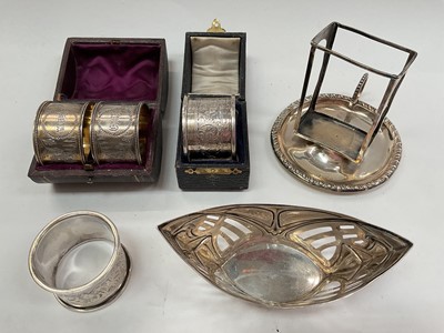 Lot 1026 - Pair of silver napkin rings in a fitted case, a single silver napkin ring in fitted case, German silver bonbon dish, silver match box holder and another silver napkin ring.
