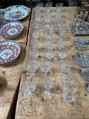 Lot 34 - A group of Victorian and later glassware, including a set of nine Edwardian etched custard cups, a set of six Victorian vine-etched sherry glasses, a pair of engraved coupes, a group of eight St...