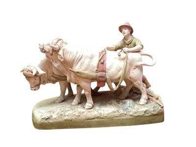 Lot 900 - A Royal Dux Model of a young farmhand harnessing a pair of oxen, model number 2185, 44cm long