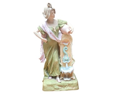 Lot 902 - Royal Dux figure of a woman in robes standing next to a fountain