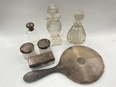 Lot 1019 - Silver backed dressing table mirror, four silver topped glass vanity jars and two cut glass perfume bottles