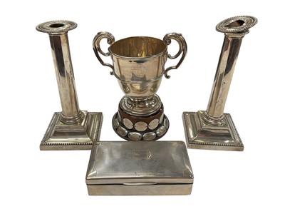 Lot 187 - George V silver trophy (London 1922), 10ozs, Pair of Edwardian silver candlesticks, (Sheffield 1902), 22.5cm in height, and a George VI silver cigarette (Chester 1937), 17cm in length.