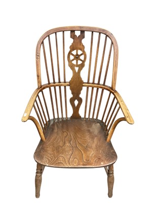 Lot 1312 - Early 19th century yew, ash and elm wheel back Windsor chair, having saddle seat on turned supports with H-shaped stretcher.