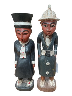 Lot 2531 - Pair of carved wood Ivory Coast figures with polychrome painted decoration, 29.5cm in height.