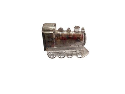 Lot 2528 - Early 20th century pressed glass candy train with tinplate decorative seal intact and with original contents