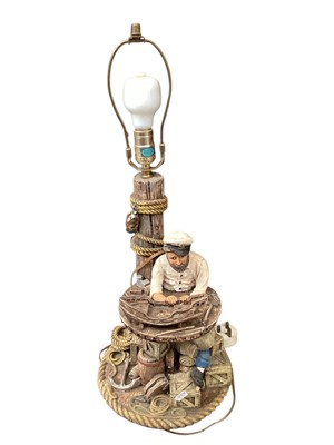 Lot 724 - Ceramic lamp of a sailor building a model boat, measuring approximately 63cm tall