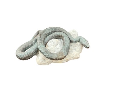 Lot 458 - Bronze model of a coiled snake on a rough fragment of marble.