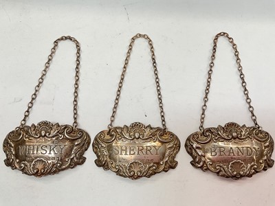 Lot 1080 - Three silver spirit labels