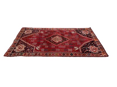 Lot 1322 - Eastern rug with central medallion on red and blue ground, 240cm x 152cm