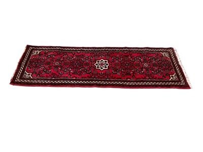 Lot 1324 - Eastern runner with central medallion on red and cream ground, 192cm x 69cm